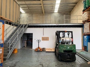A picture of a grey structural mezzanine floor in a warehouse.