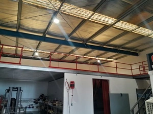 A picture of a grey and red Mezzanine Floor in a warehouse.