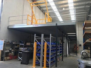 A mezzanine floor with a yellow up and over pallet gate.