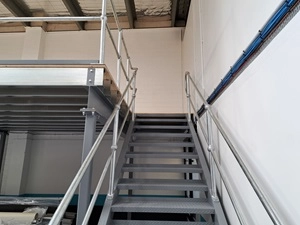 A silver mezzanine floor with staircase.